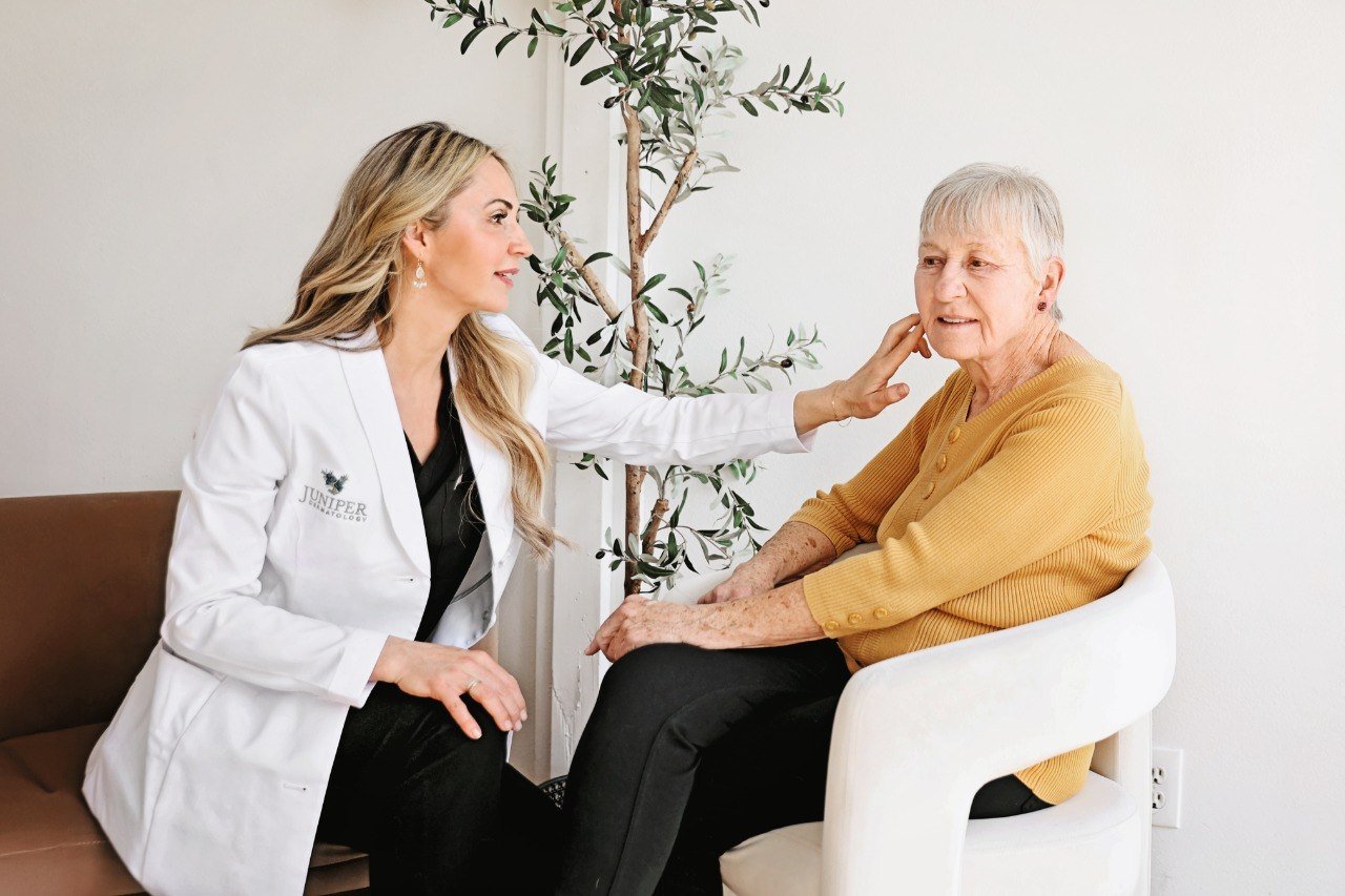 Dr. Karla Pivik, board-certified dermatologist, examining a patient at Juniper Dermatology in Bend, Oregon