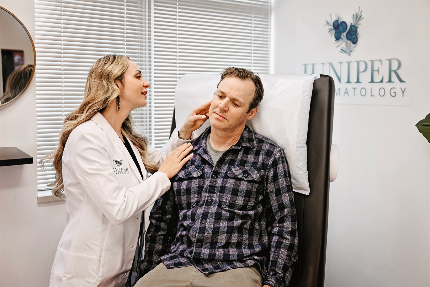 A Juniper Dermatology dermatologist examining a patient's face during a skin cancer screening in Bend, Oregon