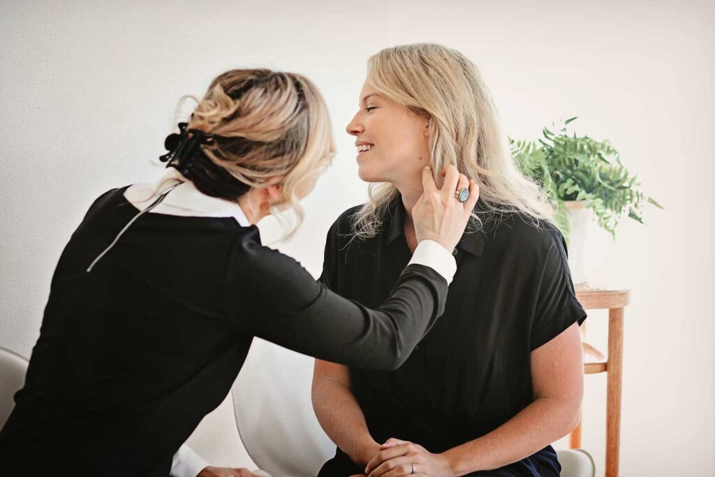 Dermatologist examining patient's face prior to a facial treatment in Bend